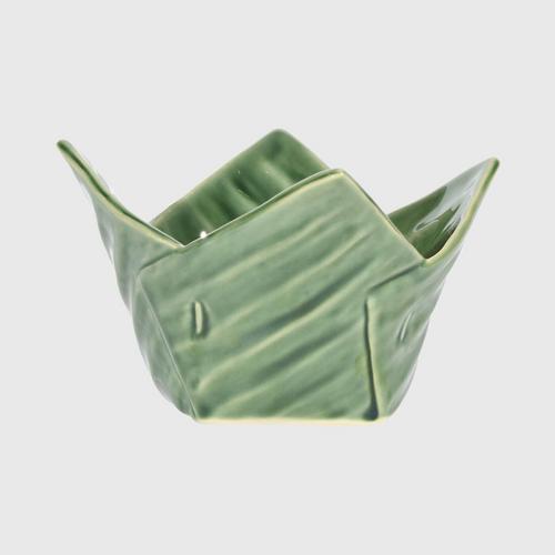 Ceramic cup in the shape of a krathong, small banana leaves